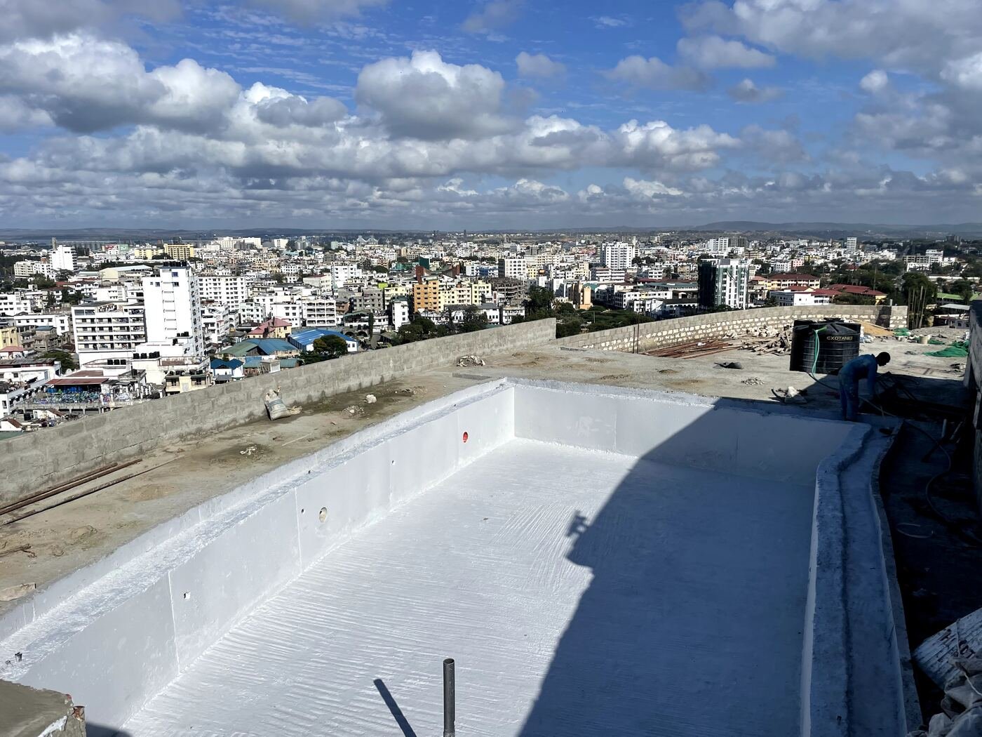 Completed swimming pool waterproofing, coastal city view