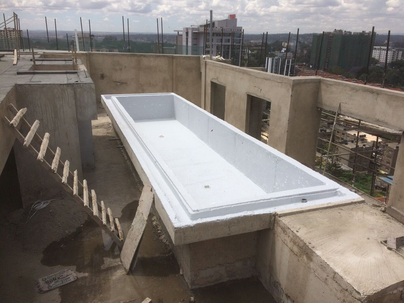 Rooftop pool waterproofing, city skyline