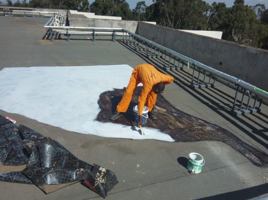 Kifaru technician repairing and re-waterproofing a flat roof