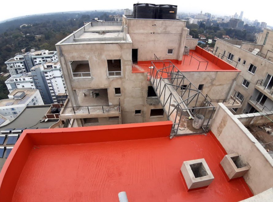 Red liquid rubber membrane on a Nairobi roof terrace